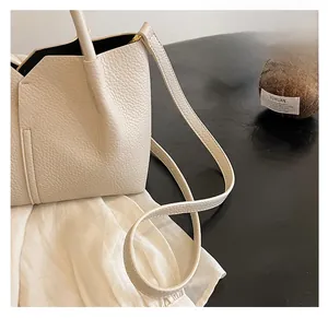 Detail of cream lychee texture tote bag featuring V-cut edge and reinforced stitching