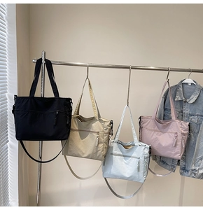 Multi-color nylon tote bags with zip pockets and adjustable straps in four colors