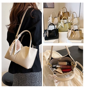 Detail view of large tote bags with interior compartments and decorative scarves