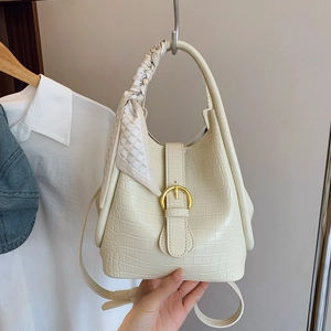 Beige crocodile embossed bucket bag with printed silk scarf handle and gold buckle detail