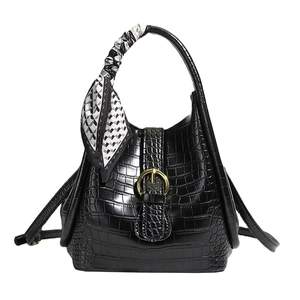 Black crocodile embossed bucket bag with gold clasp and decorative silk scarf handle