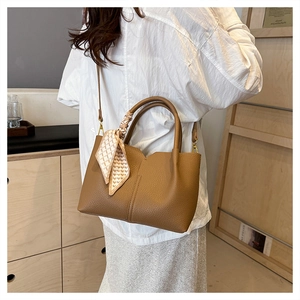 Brown lychee leather tote bag featuring elegant vertical stitching and a heart pattern scarf