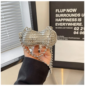 Macro view of peanut-shaped silver evening bag encrusted with sparkling rhinestones
