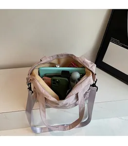 Detail view of large mauve tote bag showing spacious interior with tablet and umbrella