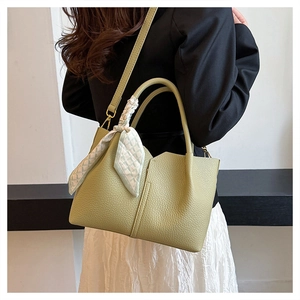 Detail of light green tote bag with lychee texture, silk scarf and detachable strap