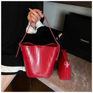 Detailed close-up of red crocodile pattern bucket bag set with inner zipper pouch