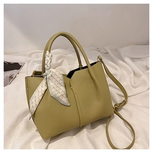 Detail of olive green tote bag with lychee grain leather and decorative silk scarf