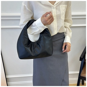 Minimalist black hobo shoulder bag with a sleek crescent moon shape in a semi-matte finish