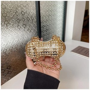 Elegant gold peanut shaped evening clutch bag with white rhinestones and a chain strap