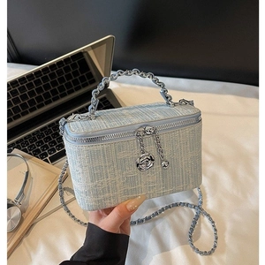 Elegant light blue tweed chain bag with silver rose charms and boxy structure