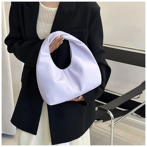 Detail of lavender crescent hobo bag with vertical stitching held by a model