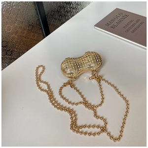 Elegant peanut-shaped gold evening bag with white rhinestones and a metal bead chain