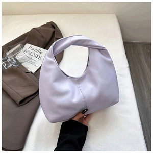 Detail of lavender purple hobo bag with twist handle and stylish faux leather texture
