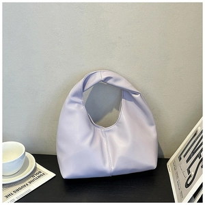 Detail of lavender pleated cloud bag with knotted handle and soft leather texture