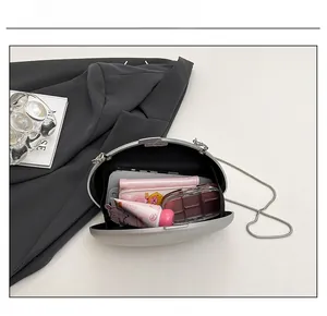 Top view of silver oval evening bag showing internal capacity for phone and makeup