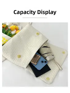 Capacity display of cream woven tote bag showing space for phone, umbrella and wallet