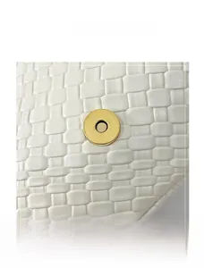 Macro shot of white woven texture and circular gold magnetic buckle on tote bag