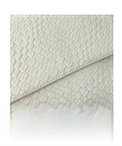 Macro detail of high-quality woven white leather texture and precision stitching on tote bag