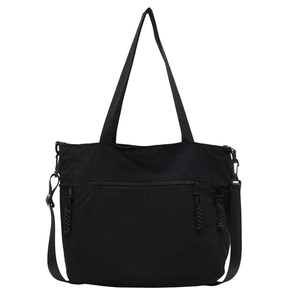 Large black canvas tote bag with multi-pocket design and adjustable shoulder straps