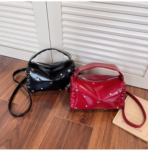Glossy leather crossbody bags in black and wine red with heart studs and ruching detail