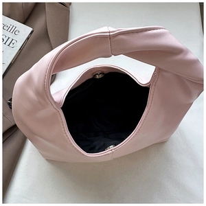 Detail of pink faux leather bag showing spacious interior with magnetic snap closure