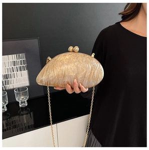 Detail of white marble acrylic clutch with gold ball clasp and metallic chain