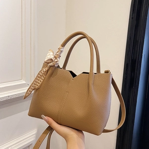 Caramel pebble leather tote bag with V-cut opening and decorative silk scarf handle