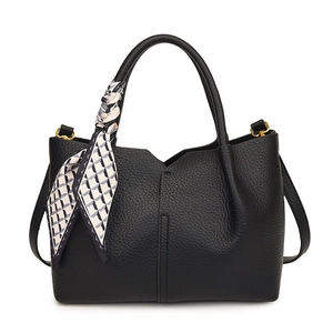 Minimalist black pebble leather tote bag with geometric silk scarf and gold hardware