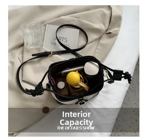 Internal capacity of contrast canvas bucket bag showing phone, umbrella and accessories