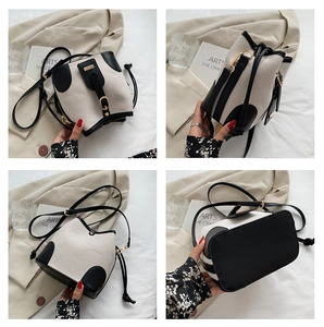 Detail showing contrast canvas bucket bag with black leather trim and drawstring closure