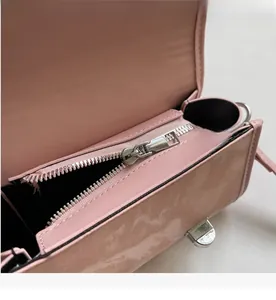 Detail of pink woven bag showing smooth silver metal zipper and interior lining