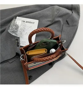Interior view of striped woven handbag showing large capacity for phone and wallet