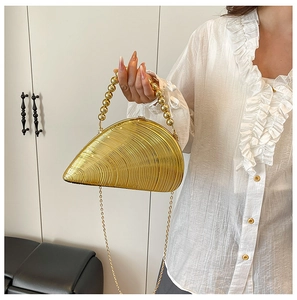 Golden shell-shaped evening clutch with textured waves and beaded handle