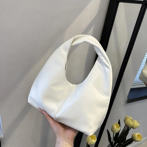 Classic white hobo shoulder bag with unique twisted handle and minimalist faux leather finish