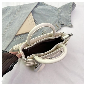 Detailed interior of creamy white lychee grain leather tote with brown fabric lining
