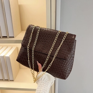 Deep brown woven chain shoulder bag with gold hardware and minimalist rectangular shape
