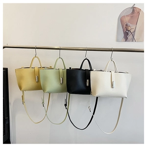 Detailed view of minimal tote bags in four colors with elegant vertical metal clasps