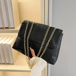 Classic black woven leather shoulder bag with gold chain strap in a stylish minimalist design