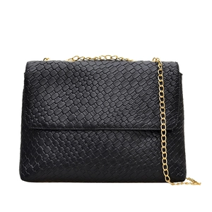Classic black woven crossbody bag with gold chain strap in a premium minimalist design