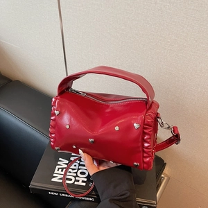 Red PU leather pillow bag with silver heart studs and ruffle side details