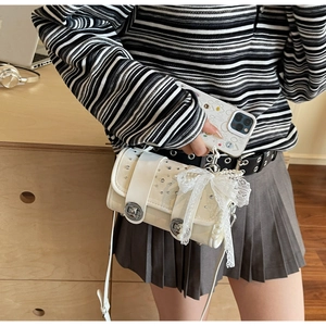 Detail of white PU leather crossbody bag with sparkling rhinestones and pearl bow accessory