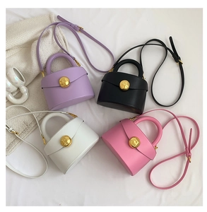 Detail of minimalist semi-circular bags with gold textured locks in four colors