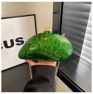 Detail of green marble acrylic evening clutch with gold ball clasp and chain
