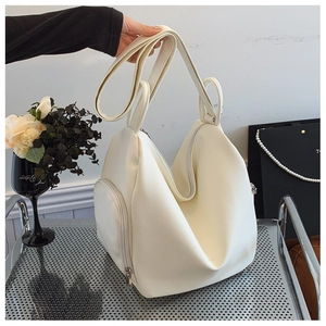 Detail of white lychee pattern PU leather bag showing spacious main pocket and side zipper