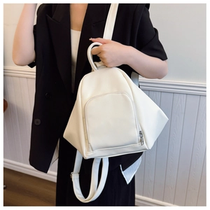 Close-up of white geometric backpack featuring lychee texture and minimalist design