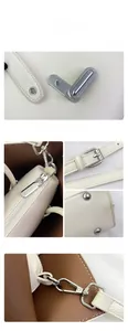 Detail of beige pebbled leather tote featuring silver hardware, twist lock and zipper