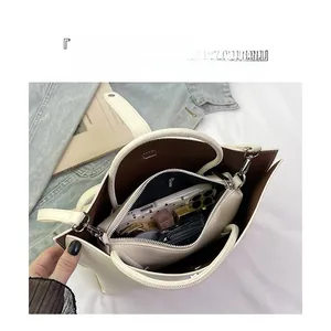 Detailed interior of beige lychee leather tote bag showing spacious double compartments