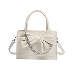 White faux leather handbag with a large bow detail, silver chain and pearl strap decor