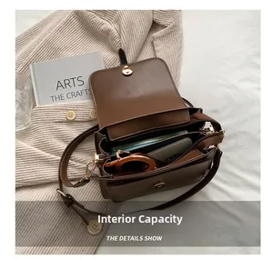 Detailed view of the brown shoulder bag interior showing compartments and storage capacity