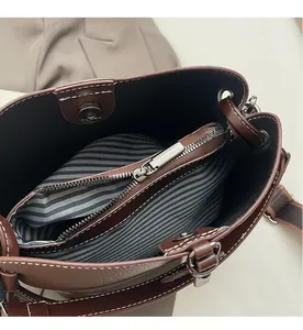 Detailansicht der braunen Leder-Eimertasche mit gestreiftem Futter und Magnetverschluss